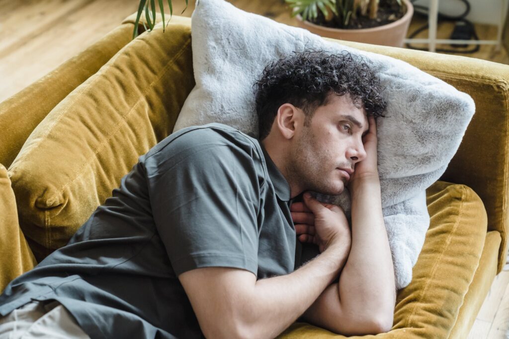 Man Lying on the Couch. Prevalence of Erectile Dysfunction among Younger Individuals