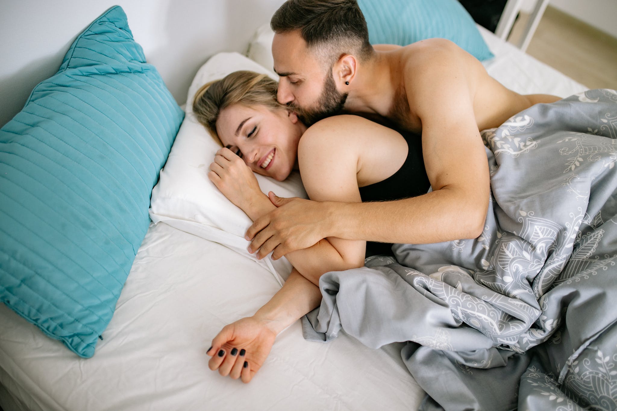 Cultivating Confidence: The Role of Mental Health in Sexual Performance. Shirtless Man Kissing a Woman while Lying on Bed